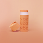 Load image into Gallery viewer, Orange Nöz sunscreen stick with cap off 
